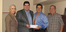 The Honorable Jerry Garza, County Commissioner Precinct 3 presents a check to the TAMIU Alumni Association 