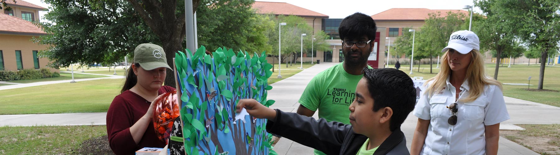 Discover TAMIU 2017 activity, where attendees add paper leaves to a paper tree