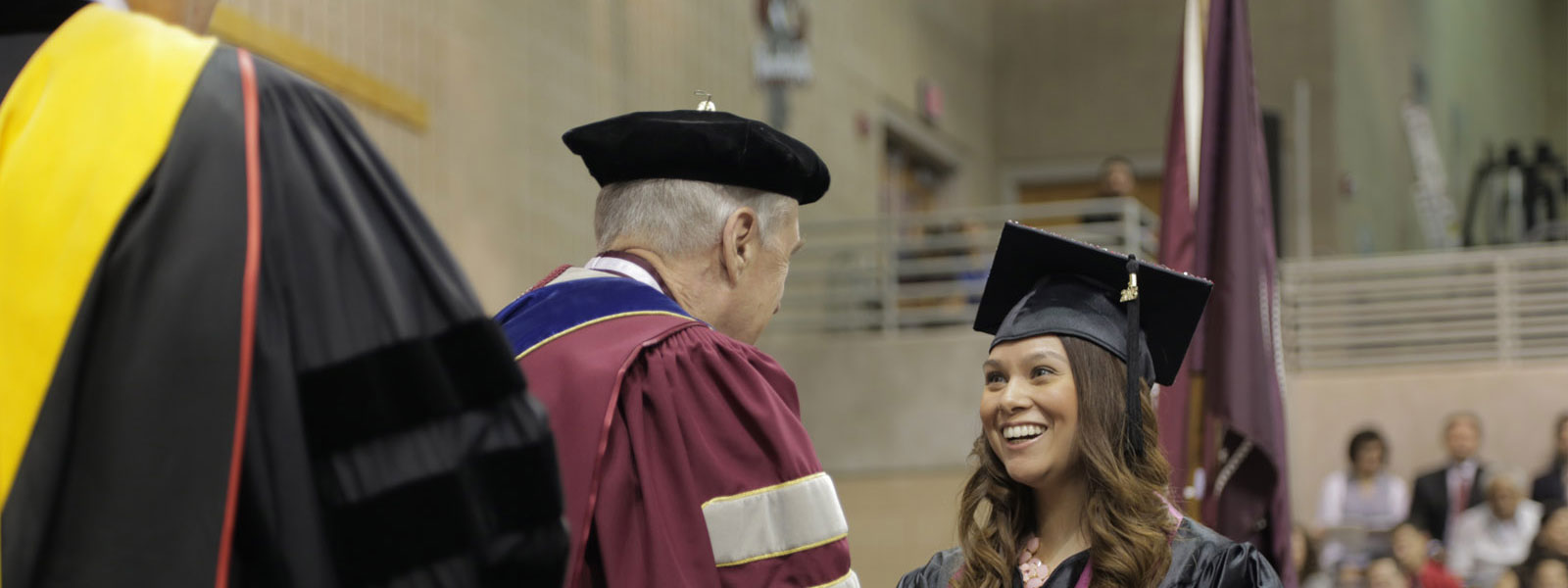 Student receiving diploma.