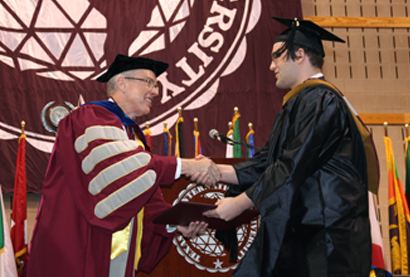 Dr.Keck Presenting Student with Diploma