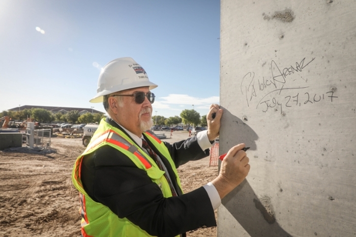 TAMIU President Dr. Pablo Arenaz adds his signature to construction last summer.