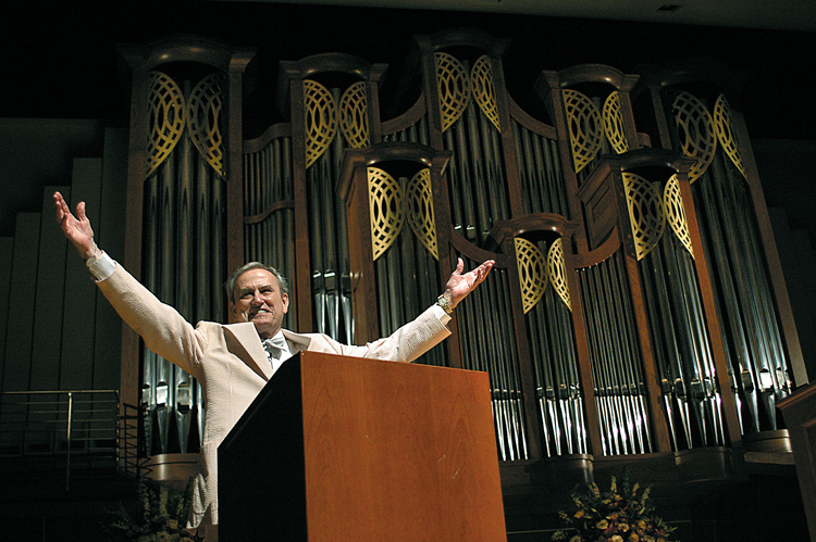 E. H. Corrigan, standing in front of the Sharkey Corrigan Organ