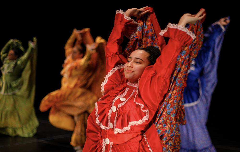 Dance students during their performing donning colorful outfits.