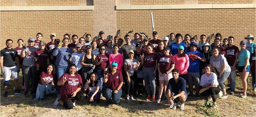 Group photo of students smiling in he garden.