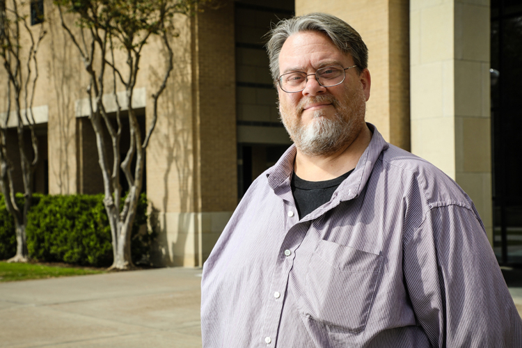 James Buckley smiling in front of Killam Library at TAMIU.