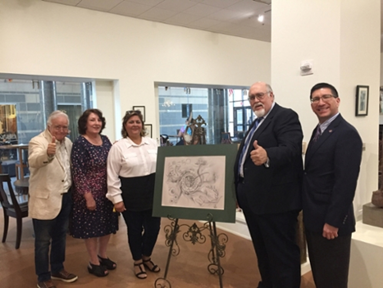 Arturo Nochebuena González , left, is pictured with University officials as he presents his commissioned artwork proposal.