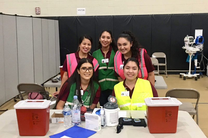 Student nurses take a photo at the volunteer center at United South High School.