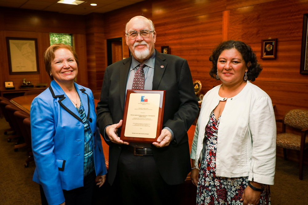 TAMIU SECC Committee members Mary Treviño, director of Migrant Programs, and Dr. Marcela Uribe, learning resources coordinator, presented a plaque recognizing the distinction to TAMIU president Dr. Pablo Arenaz.