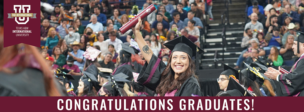 Smiling graduate at Commencement ceremony holding up diploma tube. The text 'Congratulations Graduates!' is written below the image.