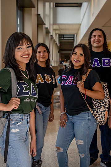 Various photos of student life at TAMIU including a group of students taking a selfie, a softball player cheering, three graduates smiling for the camera, deer laying on campus grounds, and a student on a laptop