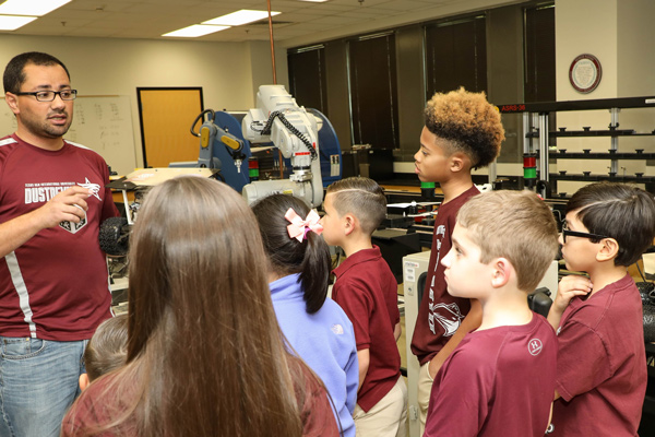 children listening to teacher at robotics lab