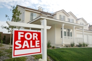 house on sale with a realtor sign