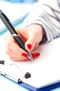 Stock photo of a person's hand holding a pen
