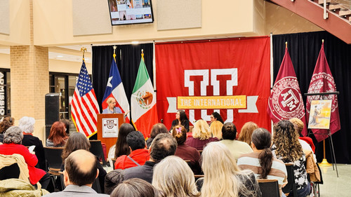 event with audience and flags in background