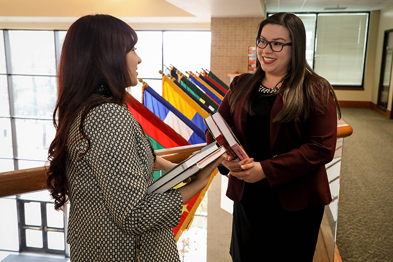 Students in the College of Business with textbooks.