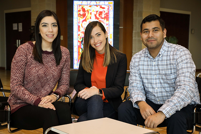 Graduate TAMIU Students sitting in the Fine and Performing Arts Center.