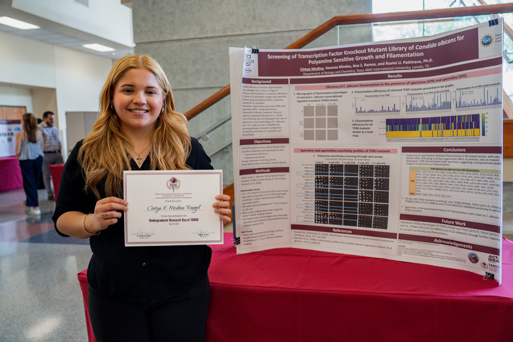 Student in front of printed poster