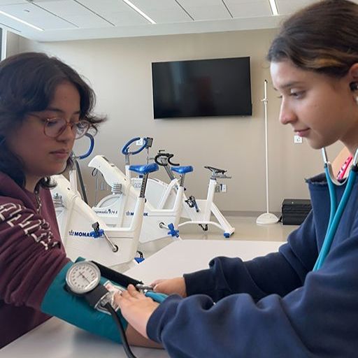 Student checking blood pressure