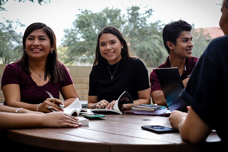 Group of students studying at an outside area