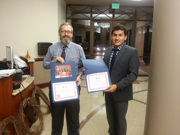 Dr. Norris congratulates Carlos Alvarez on his performance at the ESMOAS Summit.