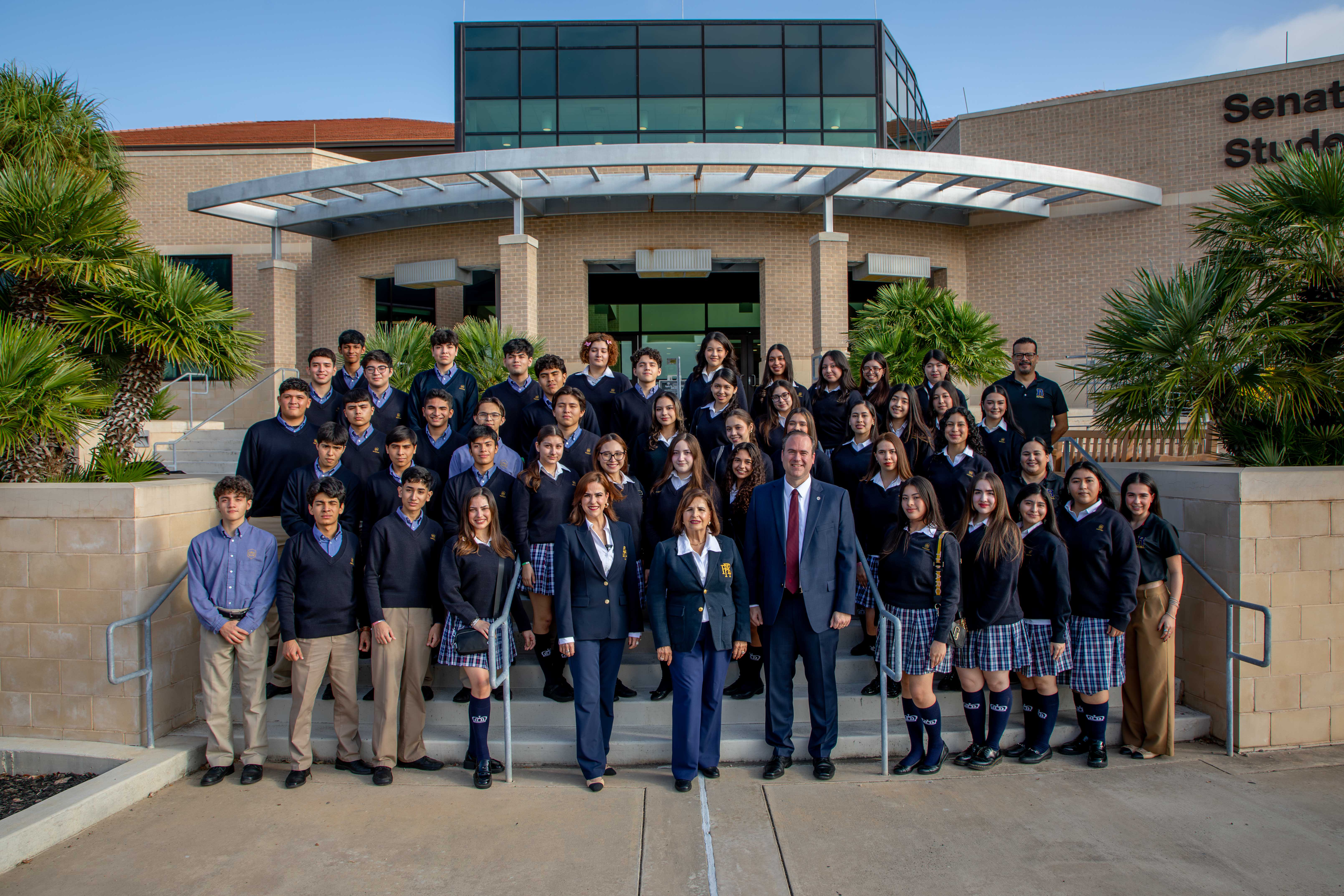 Colegio Royal students, administration stand for a photo alongside TAMIU administration.