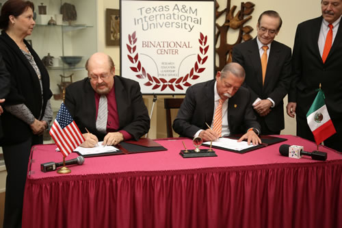 The Governor of Tamaulipas, México, Egidio Torre Cantú (right), joins Texas A&M International University provost and vice president for Academic Affairs, Dr. Pablo Arenaz, in signing a Memorandum of Agreement in ceremonies Thursday morning at TAMIU’s Helen Richter Watson Gallery.