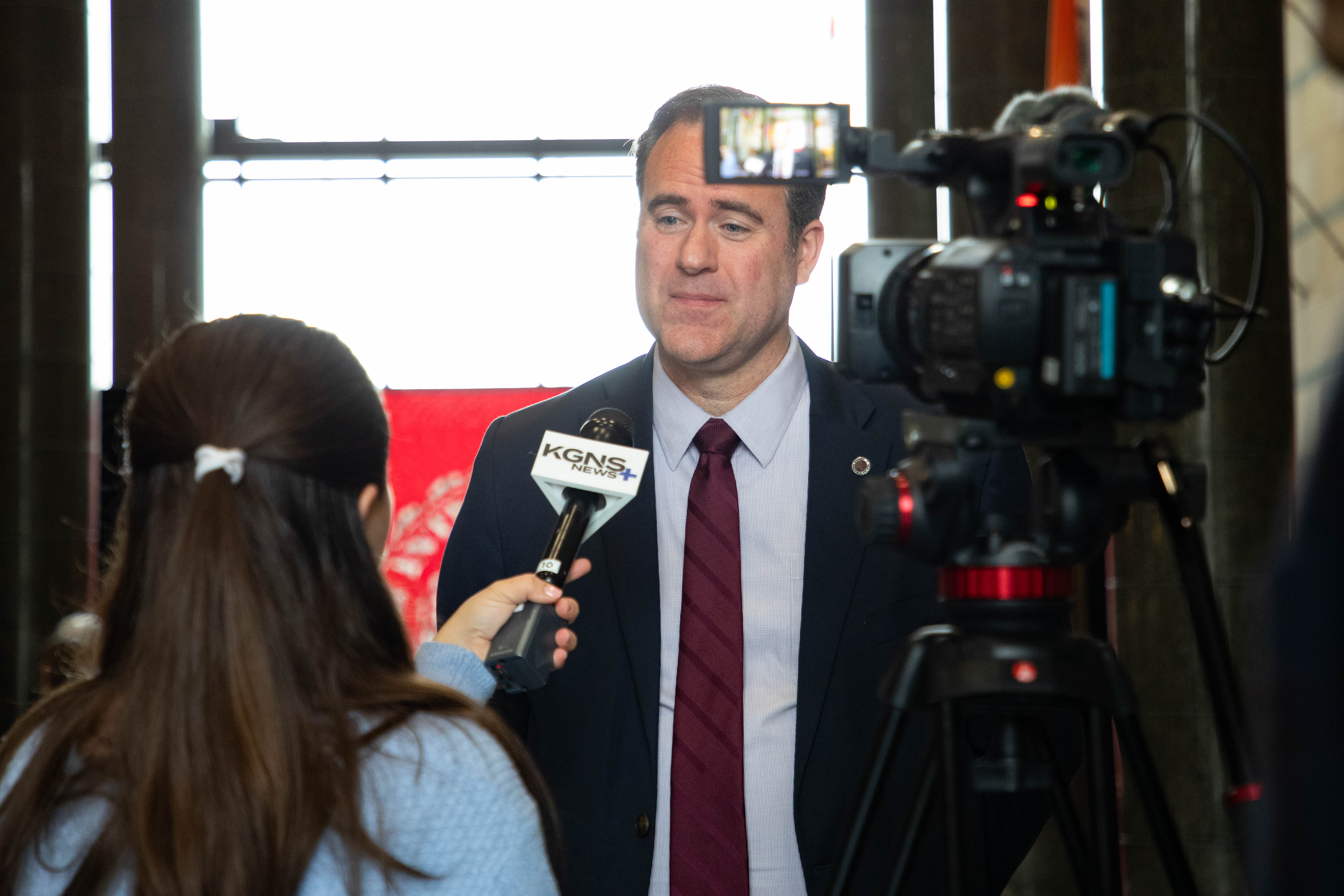 Dr. Maynard speaks on camera during a local media interview.