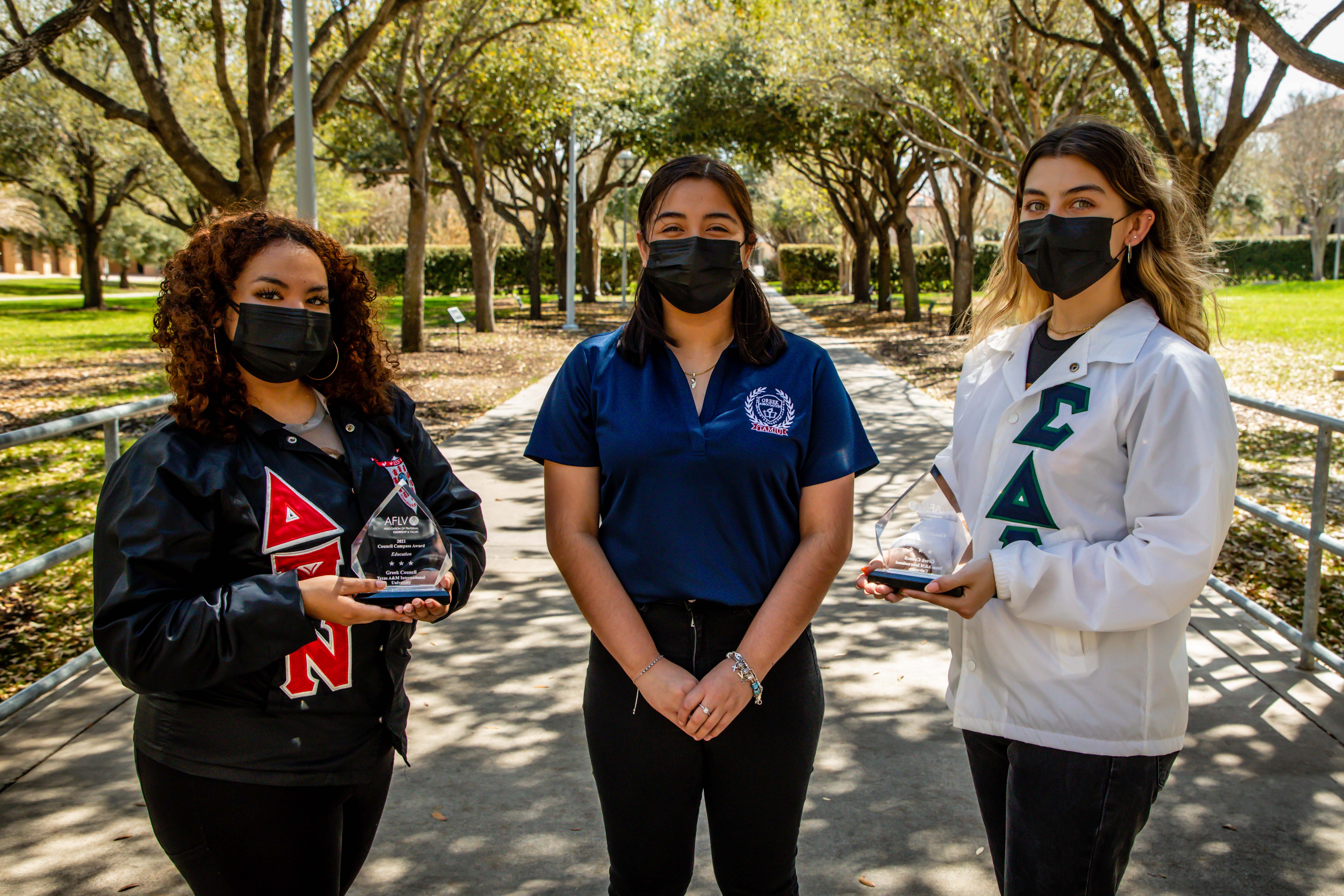 Texas A&M International University Greek Council representatives proudly hold their recent awards. They are, from left to right, Astrid Veliz, Victoria Ortiz and Barbara Pérez.  