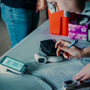 Woman inspecting a blood pressure monitor.