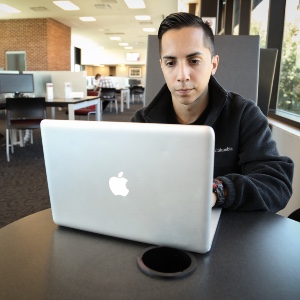 TAMIU Student on a laptop