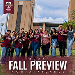 Students in TAMIU Spirited Shirts in Front of a Fall Preview 2025 Graphic