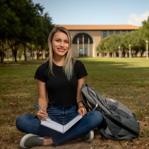 Student sits in front of the Sue and Radcliffe Killam Library