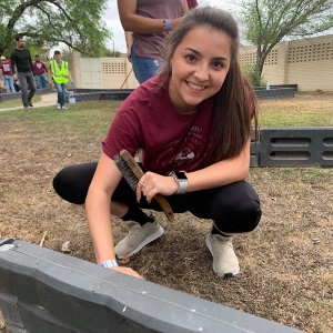 Student helps paint playground equipment at The Big Event 2019.