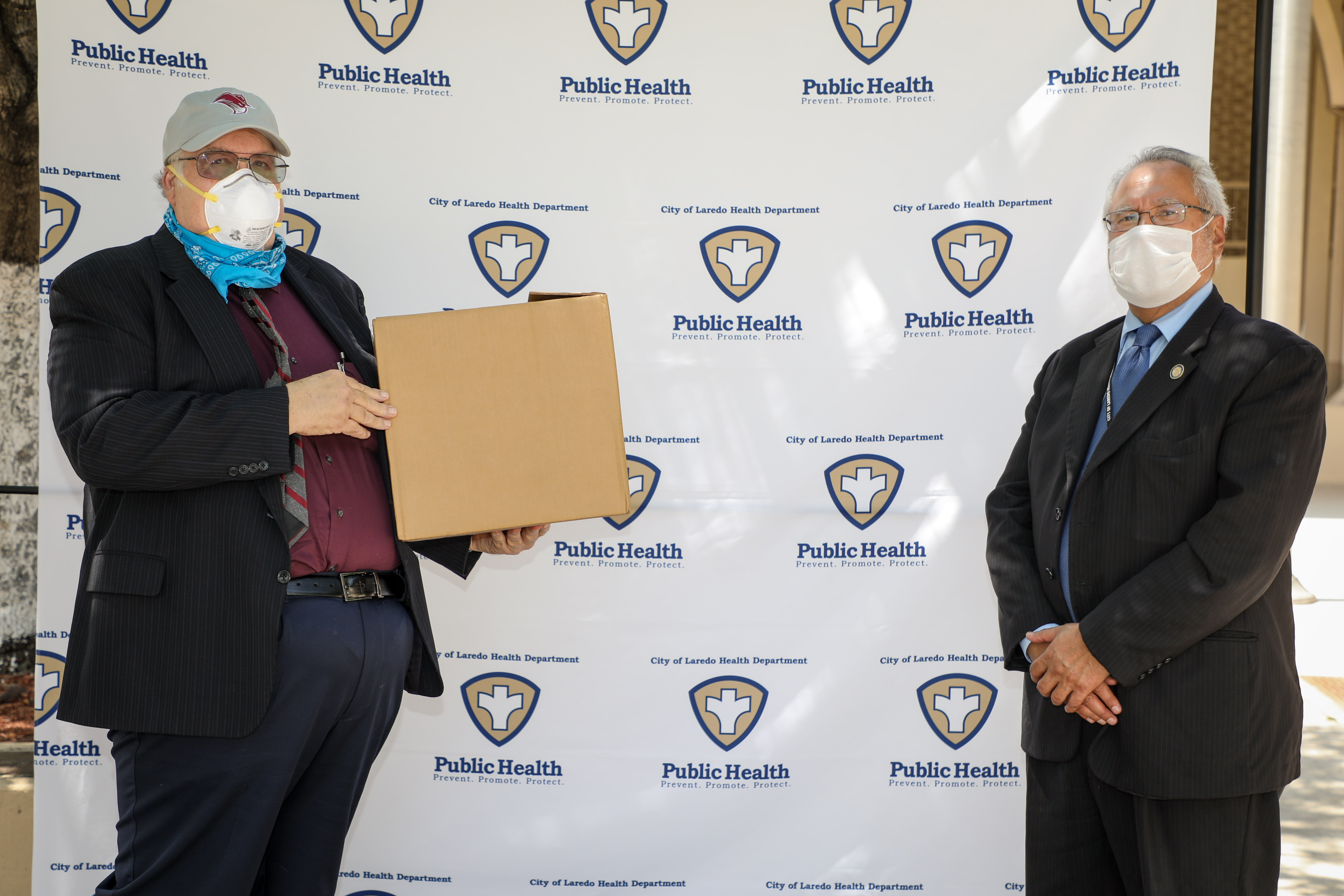 President Dr.Pablo Arenaz presenting COVID-19 sampling kits to Laredo Health Department Director, Dr. Hector Gonzalez.