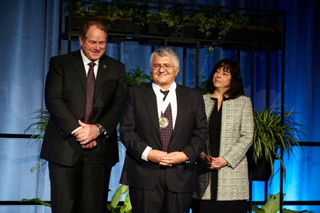 Dr. Roberto Heredia, center, is congratulated after being named a Regents Professor by The Texas A&M University System Board of Regents. Presenting Dr. Heredia with his Award are, left, Regent Chairman Cliff Thompson and right, Regent Vice Chairman Elaine Mendoza.