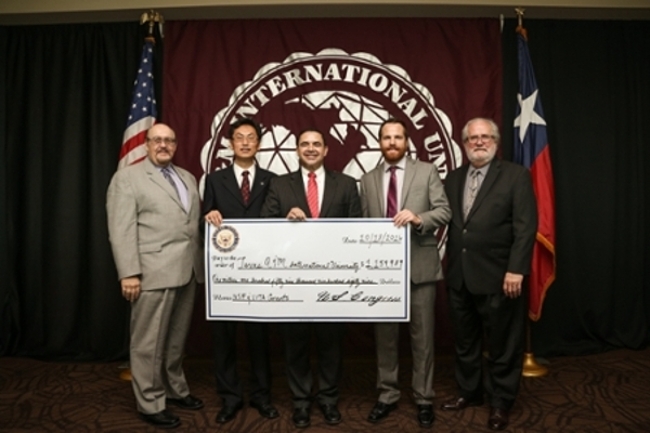 Congressman Cuellar ('82) celebrates the announcement of two TAMIU grants with (L to R), TAMIU interim president Dr. Pablo Arenaz, Dr. Runchang Lin, TAMIU co-principal investigator; Cong. Cuellar, Dr. Jack Byham, TAMIU-Vita program coordinator, and Dr. Tom Mitchell, TAMIU interim provost.