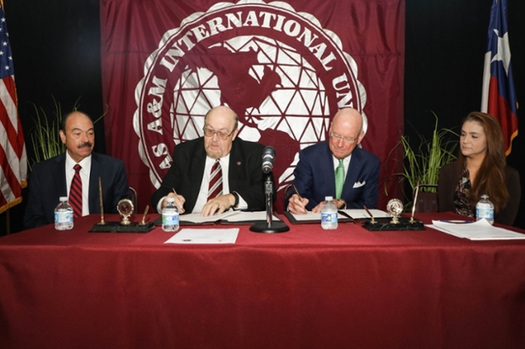 UT Health San Antonio officials join TAMIU counterparts to sign an historic agreement for health professions education. Left to right, Dr. David Shelledy, Dean, UT Health San Antonio School of Health Professions;  Dr. Pablo Arenaz, President, TAMIU;  Dr. William Henrich, President, UT Health San Antonio, Dr. Claudia San Miguel, Dean, TAMIU College of Arts and Sciences.