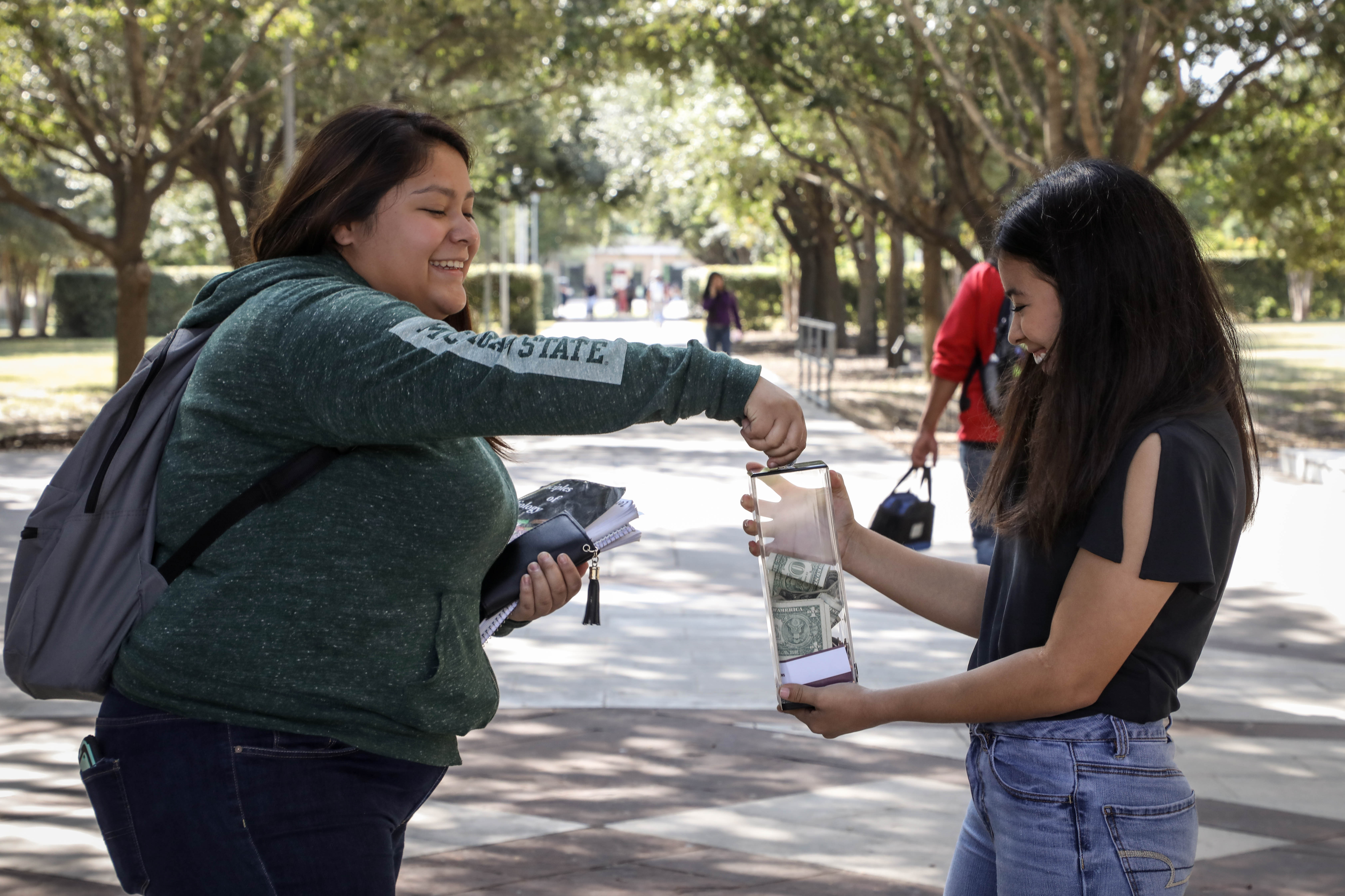 TAMIU student donating in penny wars