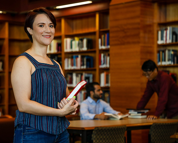 Student holding a textbook at the Killam Library