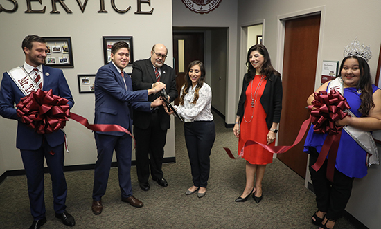 President Dr. Pablo Arenaz joins Mr. and Ms. TAMIU, Ryan Hodgson and Valerie Nunez, as well as Student Government Association president Gabriel Martinez, Dusty's Food Pantry coordinator Pauline Arredondo and TAMIU vice president for Student Success Dr. Minita Ramirez. for the ribbon-cutting for the Pantry.