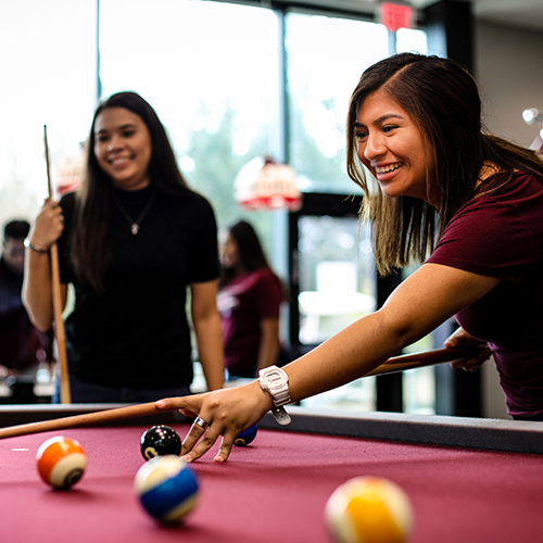 Students playing billiards