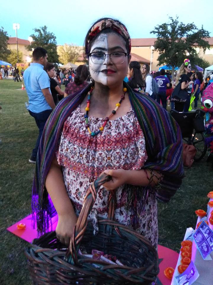 Student in halloween make up posing with basket