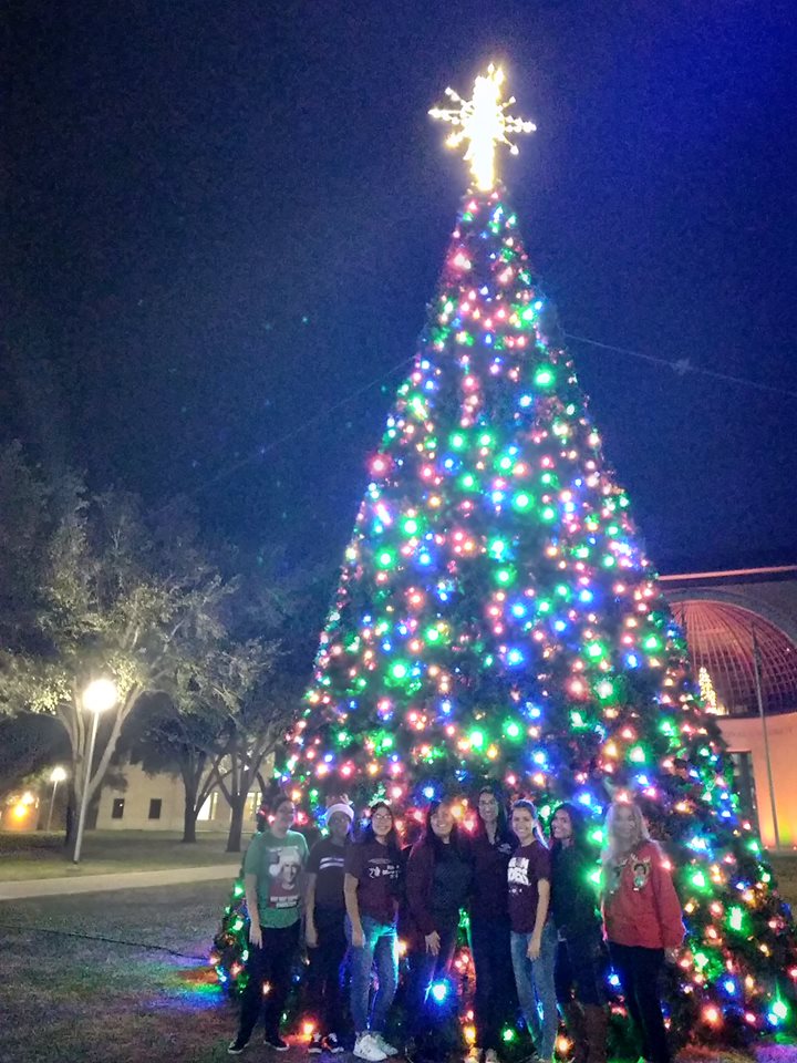 Christmas tree with group of students in front