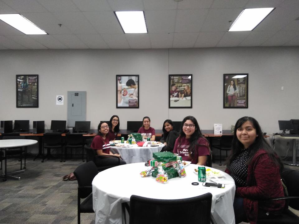 Students sitting in tables in a Christmas party