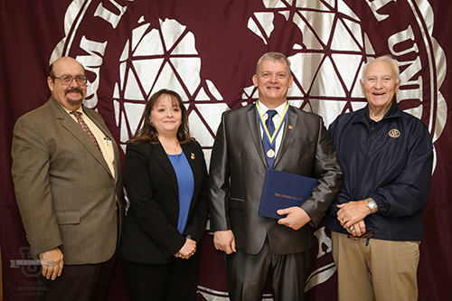 Image of Dr. Arenaz presenting award to Dr. Colin Campbell