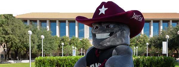 TAMIU's mascot Dusty pointing at the camera during a basketball game