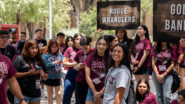 Students outside holding signs