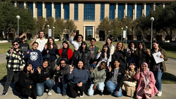 International students posing for the camera in front of the Killam Library