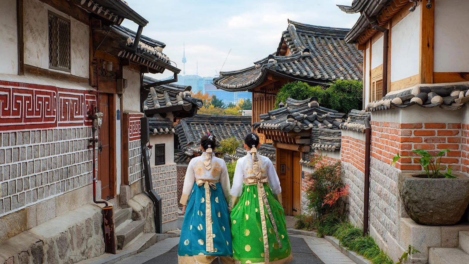 South Korea Two Girls Holding Hands Walking Down a Street in Culture Attire