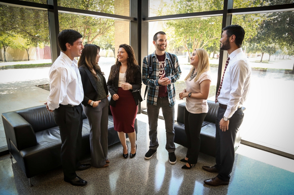 Students talking in building with windows